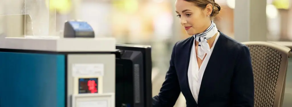 airport worker using an airport management system software on a computer