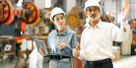 site managers checking standard operating procedure templates using a laptop