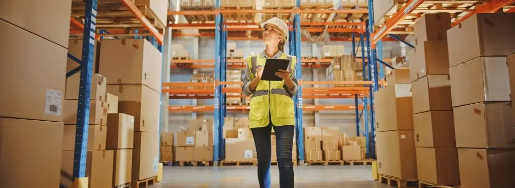 a supply chain manager checking warehouse inventory using a supply chain management software on a tablet|e2open Supply Chain Management Software|Logility Supply Chain Management Software|Luminate Platform by Blue Yonder Supply Chain Management Software|Manhattan Active Supply Chain Management Software|Oracle Fusion Cloud SCM Supply Chain Management Software|RapidResponse by Kinaxis Supply Chain Management Software