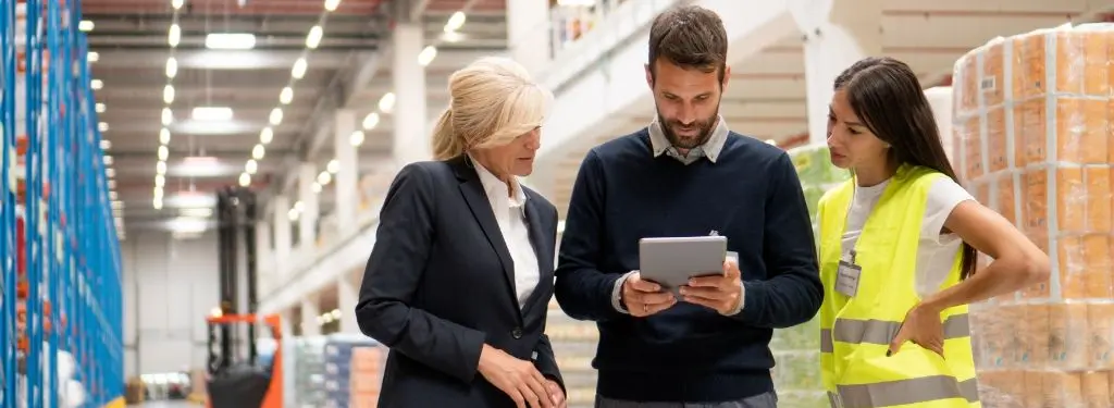 workers using a building management software on their device