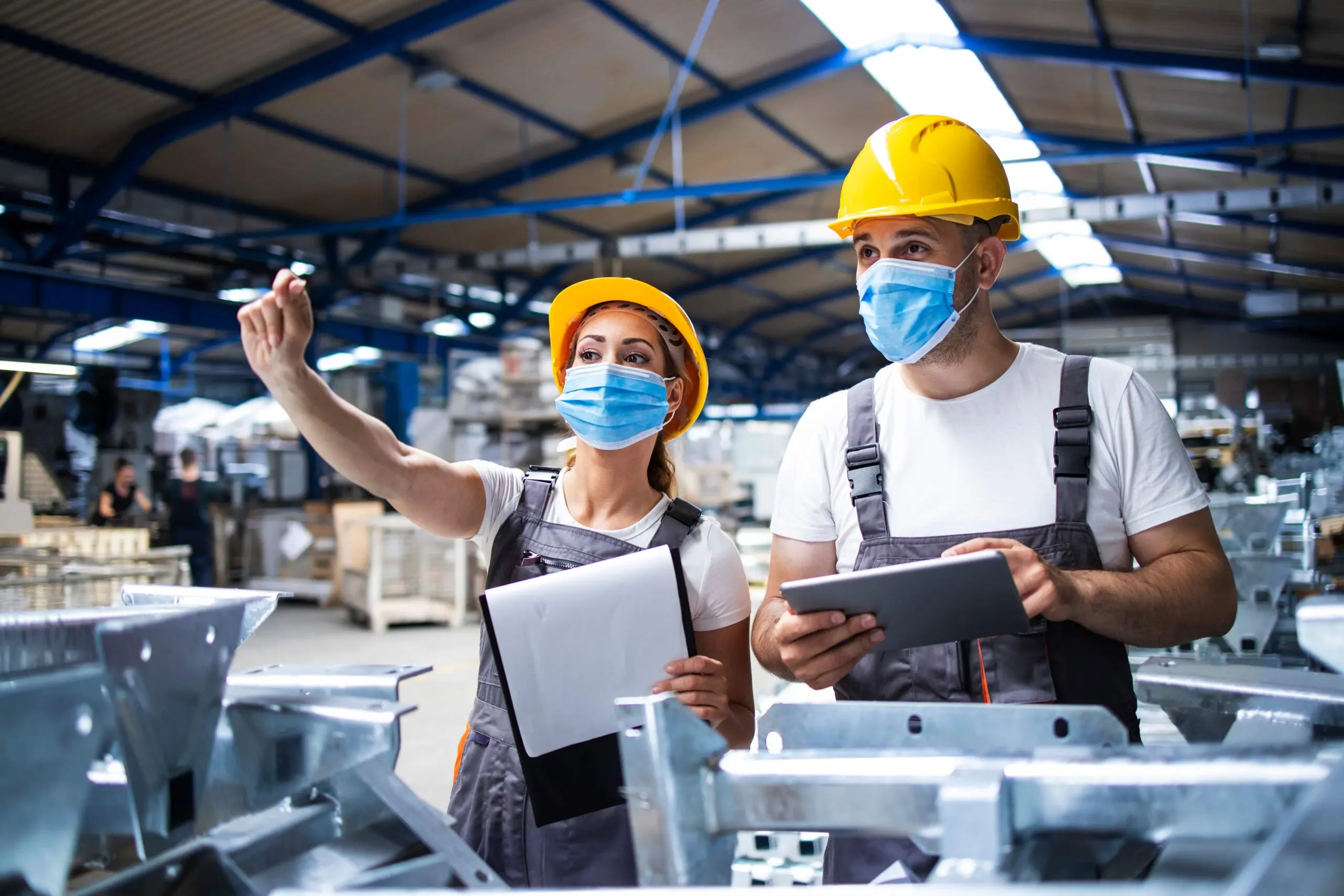 two health and safety compliance officers using a digital solution on a tablet to discuss safety management protocols