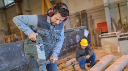 a construction worker wearing hearing protection as a safety measure outlined in a noise hazard identification checklist