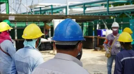 construction workers being briefed about safety protocols while sharing toolbox talk examples