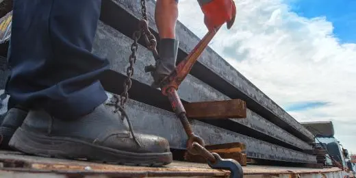 a professional doing load securing checks before transport