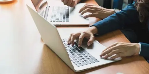 office employees answering workplace culture surveys on their laptops