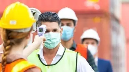 workers doing their part in ensuring employee safety by checking temperature on worksite