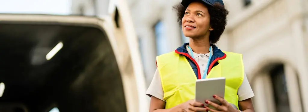 a warehouse manager using a global trade management software on a tablet for operations