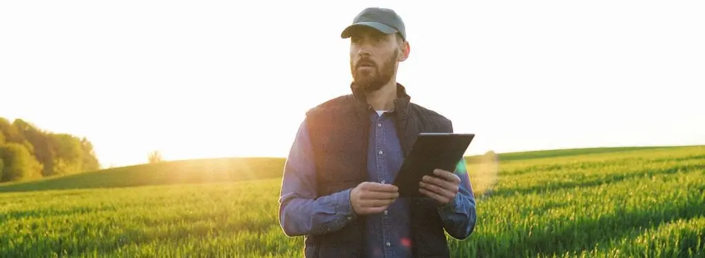 a professional in the field collecting data using a field data collection app on a tablet|ArcGIS Field Data Collection App|Dataddo Field Data Collection App|Mergin Maps Field Data Collection App|QField Field Data Collection App|Caspio Field Data Collection App|Caspio Field Data Collection App|ZAP Data Hub Field Data Collection App