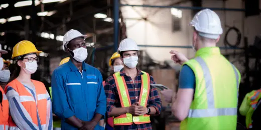 Workers having a construction site induction before the formal start of a construction project