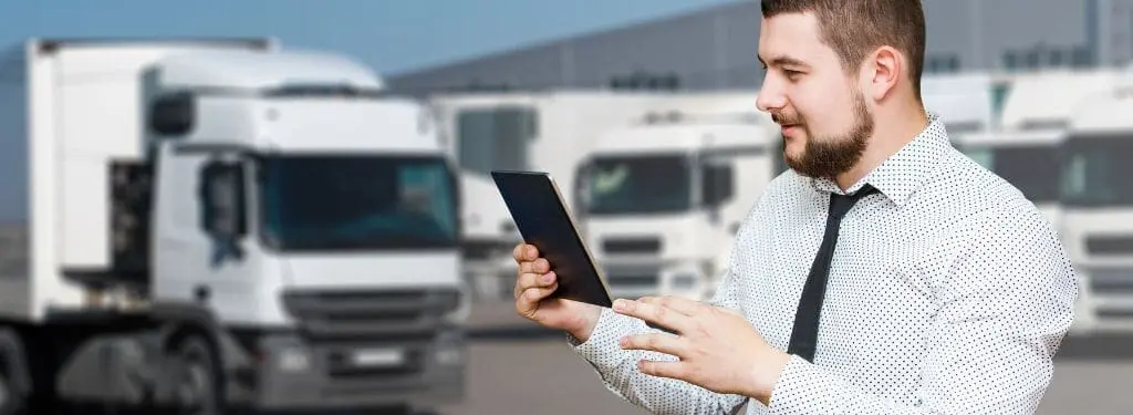 fleet manager using a fleet management software on his tablet|AUTOsist|Avrios|FleetWave|Teletrac Navman DIRECTOR|Zubie|RTA