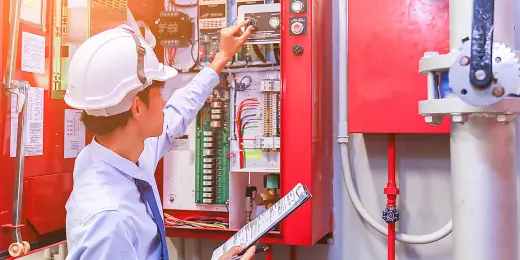 A safety officer conducting an internal fire alarm inspection